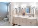 Bathroom with double vanity, white cabinets, white toilet, and neutral walls at 4162 Gateswalk Se Dr, Smyrna, GA 30080