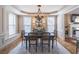 Formal dining room with wainscoting, natural light, an elegant chandelier, and seating for six at 4162 Gateswalk Se Dr, Smyrna, GA 30080