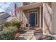 Inviting entryway featuring a brick facade, manicured shrubbery, and a blue front door with glass accents at 4162 Gateswalk Se Dr, Smyrna, GA 30080