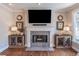 Stylish living room featuring a modern fireplace, custom cabinetry, and hardwood floors at 4162 Gateswalk Se Dr, Smyrna, GA 30080