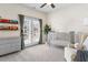 Bedroom with grey furnishings, double doors, and a ceiling fan at 4535 Atley Woods Se Dr, Atlanta, GA 30339