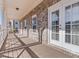 Inviting covered deck with brick exterior and glass paneled door entrance, providing outdoor living space at 4535 Atley Woods Se Dr, Atlanta, GA 30339