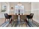 Elegant dining room featuring a modern light fixture, stylish chairs, and a large window at 4535 Atley Woods Se Dr, Atlanta, GA 30339