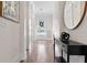 Bright hallway featuring hardwood floors, elegant decor, and natural light from the front door at 4535 Atley Woods Se Dr, Atlanta, GA 30339