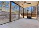 Covered patio with brick wall, ceiling fan, and screened windows overlooking the yard at 4535 Atley Woods Se Dr, Atlanta, GA 30339