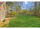 Beautiful backyard with a large grassy area, framed by a wooden fence, and a basketball hoop at 848 Gateshead Ct, Lawrenceville, GA 30043