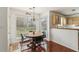 Charming dining area featuring a rustic wood table, large windows, and view of backyard at 848 Gateshead Ct, Lawrenceville, GA 30043