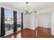 Open view of dining room with hardwood floors and black curtains overlooking front yard at 848 Gateshead Ct, Lawrenceville, GA 30043