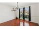 Elegant dining room with hardwood floors, chandelier, and a view of the front yard at 848 Gateshead Ct, Lawrenceville, GA 30043