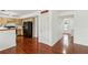 Open-concept view of kitchen and dining area featuring wooden cabinetry and hardwood flooring at 848 Gateshead Ct, Lawrenceville, GA 30043