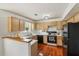 Efficient kitchen with ample cabinet space, and appliances, all complemented by warm lighting and a view to the outside at 848 Gateshead Ct, Lawrenceville, GA 30043