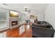 Inviting living room features a brick fireplace, hardwood floors, and seamlessly connects to the breakfast area and kitchen at 848 Gateshead Ct, Lawrenceville, GA 30043