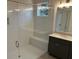 Modern bathroom with glass shower, bench, and dark cabinets at 204 Saratoga Dr, Acworth, GA 30102