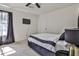 Cozy bedroom with a comfortable bed, soft carpet, and a view of the window at 3915 Basil Sw Way, Atlanta, GA 30331