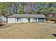Charming single story home with a gray roof, a dark garage door, and white brick walls at 3915 Basil Sw Way, Atlanta, GA 30331
