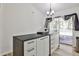 The kitchen features white cabinets, dark countertops, pendant lighting, and access to an outdoor deck at 3915 Basil Sw Way, Atlanta, GA 30331
