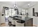 Bright, open kitchen with white cabinets, stainless steel appliances, and a long island with barstool seating at 3915 Basil Sw Way, Atlanta, GA 30331