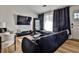 Living room featuring trendy décor, stylish furnishings, a flat-screen TV, and a spacious sectional at 3915 Basil Sw Way, Atlanta, GA 30331