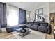 A modern living room boasts a large sectional sofa, stylish decor, and plenty of natural light at 3915 Basil Sw Way, Atlanta, GA 30331