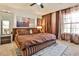 Spacious main bedroom featuring a luxurious bed, plush carpet, and plenty of natural light at 3915 Basil Sw Way, Atlanta, GA 30331