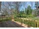 This backyard deck has wooden railings overlooking the lush, green backyard at 5153 Westbrook Pl, Union City, GA 30291