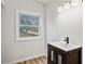 This bathroom features a white vanity with a dark wood cabinet and a window at 5153 Westbrook Pl, Union City, GA 30291