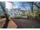 Exterior rear view of home with wooden deck, stairs and landscaping at 1130 Ashbrook Dr, Lawrenceville, GA 30043