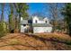 Exterior view of a two-story home featuring a well-maintained yard and partial fence at 1130 Ashbrook Dr, Lawrenceville, GA 30043