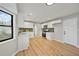 Modern kitchen with white cabinets, stainless steel appliances, and light wood floors at 1130 Ashbrook Dr, Lawrenceville, GA 30043