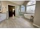 Well-appointed bathroom featuring a soaking tub, walk-in shower, and large window at 11935 Lexington Woods Dr, Alpharetta, GA 30005