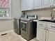 Well-equipped laundry room featuring modern appliances, sink, and ample storage space at 11935 Lexington Woods Dr, Alpharetta, GA 30005