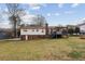 A backyard view of a two-story home featuring a well-maintained lawn and a cozy back deck at 2441 Hidden Hills Dr, Marietta, GA 30066