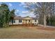 Inviting split-level home with a brick facade, cozy front porch, and beautiful mature trees at 2441 Hidden Hills Dr, Marietta, GA 30066