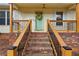 Charming front porch with brick steps and a decorative wreath adorning the front door at 2441 Hidden Hills Dr, Marietta, GA 30066