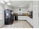 Bright kitchen with white cabinets, tile floors, and a view of the backyard at 2441 Hidden Hills Dr, Marietta, GA 30066