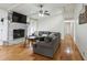 Cozy living room with hardwood floors, a brick fireplace, and a comfortable gray sofa at 2441 Hidden Hills Dr, Marietta, GA 30066