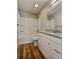 Bright bathroom features a shower-tub combo and granite vanity with white cabinets at 5550 Mccrossin Cir, Stonecrest, GA 30038