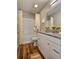 Updated bathroom boasts granite vanity, white cabinets, and a shower-tub combo with curtains at 5550 Mccrossin Cir, Stonecrest, GA 30038