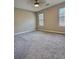 A spacious carpeted bedroom with two large windows offers ample natural light and a serene ambiance at 5550 Mccrossin Cir, Stonecrest, GA 30038