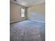 Neutral bedroom with carpet and large window at 5550 Mccrossin Cir, Stonecrest, GA 30038