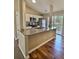 Open kitchen with granite counters, a breakfast bar, white cabinetry and stainless appliances overlooks deck access at 5550 Mccrossin Cir, Stonecrest, GA 30038