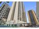 Exterior view of high-rise building featuring balconies, tennis courts, and a covered lounge area at 1280 W Peachtree Nw St # 2613, Atlanta, GA 30309