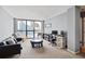 Spacious living room with floor-to-ceiling windows and comfortable seating, perfect for relaxing or entertaining at 1280 W Peachtree Nw St # 2613, Atlanta, GA 30309
