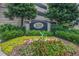Community entrance sign with flower beds and mature trees providing an inviting entrance to the property at 1280 W Peachtree Nw St # 2613, Atlanta, GA 30309