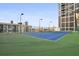 A well-maintained tennis court showcases a blue surface, lighting, and city views at 1280 W Peachtree Nw St # 2613, Atlanta, GA 30309
