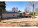 Exterior view of a home with a backyard, stone patio, grill and an outdoor seating area at 1341 Longwood Sw Dr, Marietta, GA 30008