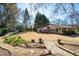 Expansive backyard featuring a stone walkway, lush landscaping, and quaint gazebo, perfect for outdoor living and entertaining at 1341 Longwood Sw Dr, Marietta, GA 30008