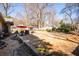 Large backyard featuring a manicured lawn, a red umbrella and garden, and hardscape at 1341 Longwood Sw Dr, Marietta, GA 30008