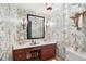 Powder room features vanity with marble countertop and decorative wallpaper at 1341 Longwood Sw Dr, Marietta, GA 30008