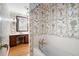 Charming bathroom featuring wallpaper and a pedestal tub at 1341 Longwood Sw Dr, Marietta, GA 30008